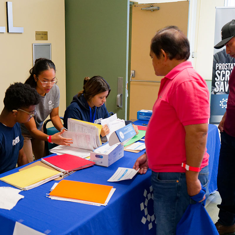 People gathered at a table at a health event