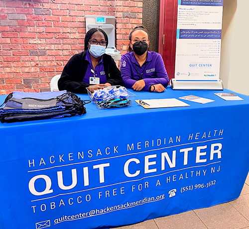 People sitting at a Quit Center Table