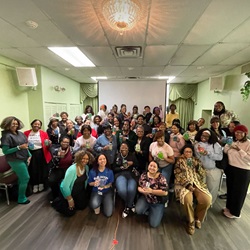 Group gathered indoors at a community wellness event